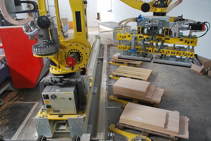 The robot loads the material onto the CNC machine