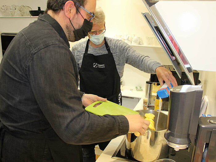 The Compass Software employees are cooking together during their lunch break