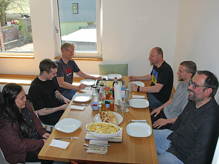 The Compass Software employees are cooking together during their lunch break