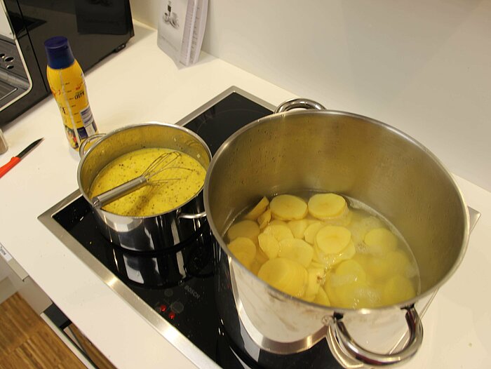 The Compass Software employees are cooking together during their lunch break